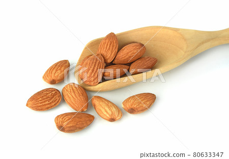 Almond and almond in wooden spoon isolated on white background 80633347