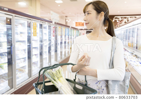 Young woman shopping at a supermarket Shopping image Young woman shopping at a supermarket Shopping image 80633703