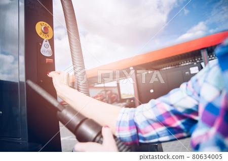 Person paying coins to self service automatic car vacuum machine. Person paying coins to self service automatic car vacuum machine. 80634005
