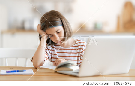 Girl doing homework or online education. 80634573