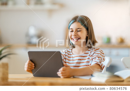 Girl doing homework or online education. 80634576