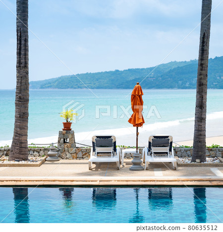 Empty beach deck chair reflecting in swimming pool 80635512