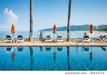 Empty beach deck chair reflecting in swimming pool 80635514