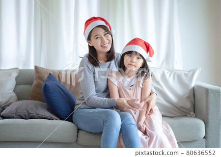 Asian Mother Daughter enjoy to celebrate Christmas and new year party at home Asian Mother Daughter enjoy to celebrate Christmas and new year party at home 80636552
