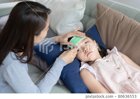 Asian mother take care of her kid which got fever and illness at home 80636553