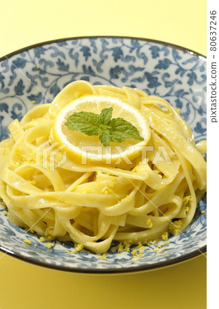 Photographed lemon cream pasta with lemon and spearmint cut into slices on a lemon-colored background 80637246