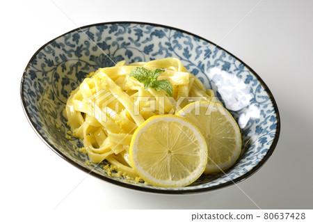 Photographed lemon cream pasta with lemon and spearmint cut into slices on a white background 80637428
