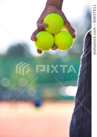Photo of senior man holding tennis balls on court Photo of senior man holding tennis balls on court 80637611