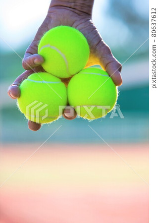Photo of senior man holding tennis balls on court Photo of senior man holding tennis balls on court 80637612