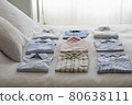 Variety Of Shirts On Bed 80638111