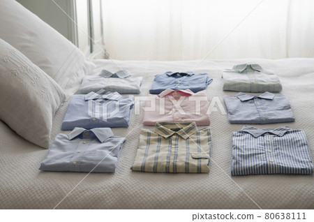 Variety Of Shirts On Bed 80638111