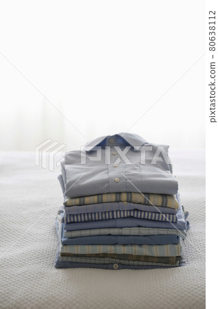 Ironed And Folded Shirts On Bed Ironed And Folded Shirts On Bed 80638112