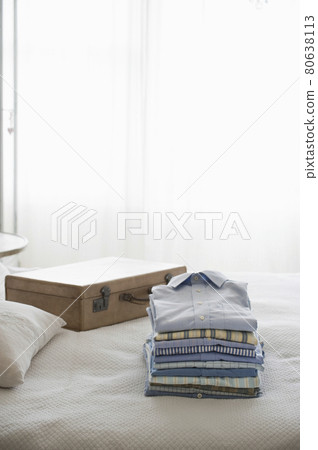 Ironed And Folded Shirts On Bed 80638113