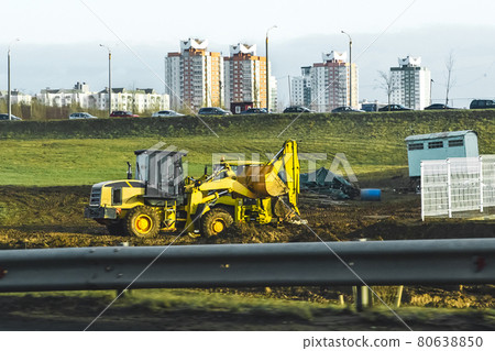 Broken two bulldozers at a construction site on the background of cars and urban buildings Broken two bulldozers at a construction site on the background of cars and urban buildings 80638850