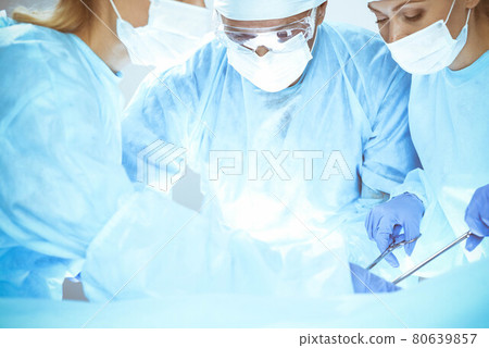 A group of surgeons is operating at the hospital. Health care concept 80639857