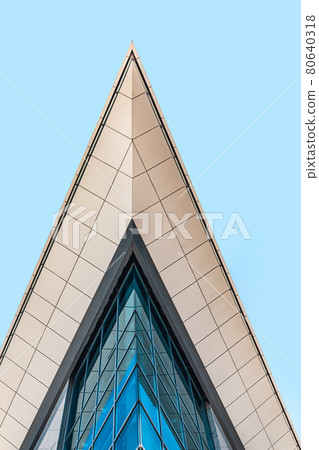 Part of modern office building with glass facade against blue sky, low angle view, crop. Skyscraper in the city center Part of modern office building with glass facade against blue sky, low angle view, crop. Skyscraper in the city center 80640318