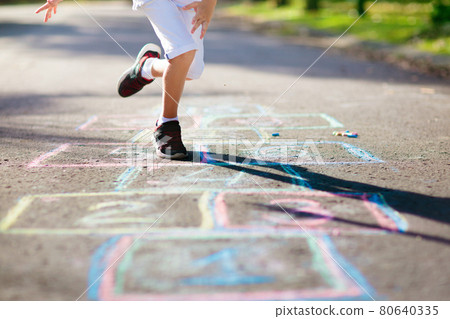 Kids play hopscotch in summer park. Outdoor game. 80640335