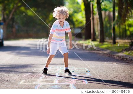 Kids play hopscotch in summer park. Outdoor game. 80640406