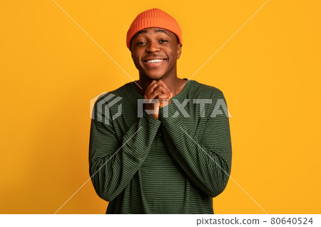 Young black guy pleading and asking for something with clasped hands 80640524