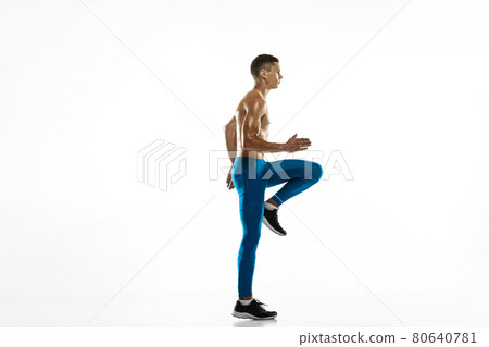 Workout. Young male athlete, runner practicing isolated on white studio background. Muscular, sportive man. Concept of sport, healthy lifestyle 80640781