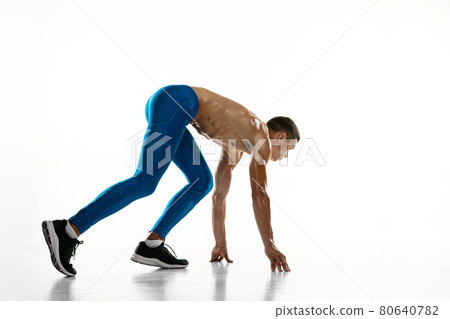 Portrait of young professional male athlete, runner isolated on white studio background. Muscular, sportive man. Concept of sport, healthy lifestyle Portrait of young professional male athlete, runner isolated on white studio background. Muscular, sportive man. Concept of sport, healthy lifestyle 80640782