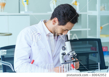 Doctor and microbiologist with vacuum tubes for samples with COVID 19 infection atypical pneumonia virus in laboratory 80642952