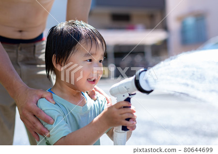 Parent and child playing in the water Parent and child playing in the water 80644699