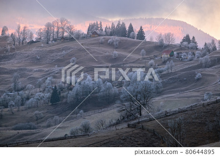 Winter coming. Last good weather days in autumn mountains countryside morning peaceful picturesque scene. Dirty road from hills to the village. 80644895