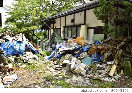 Garbage mansion. A pile of garbage illegally dumped in an unoccupied house. Garbage mansion. A pile of garbage illegally dumped in an unoccupied house. 80645391