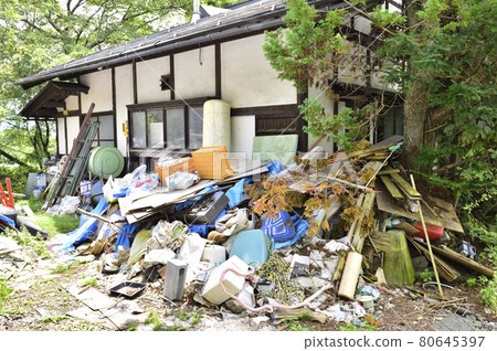 Garbage mansion. A pile of garbage illegally dumped in an unoccupied house. 80645397