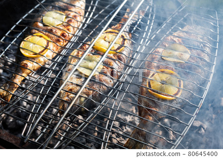 Grilling dorada fish on grill 80645400