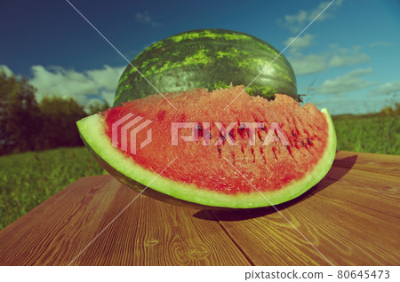 Watermelon slices on a wooden table Watermelon slices on a wooden table 80645473