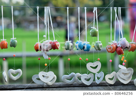 Colorful hanging mobile aganist blurred nature background Colorful hanging mobile aganist blurred nature background 80646256