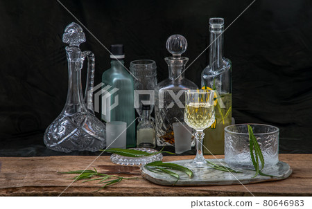 Ice cold Marijuana cannabis CBD infused drink in a crystal clear glass with green marijuana leaf on wooden background. Ice cold Marijuana cannabis CBD infused drink in a crystal clear glass with green marijuana leaf on wooden background. 80646983