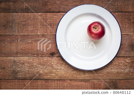 red apple on metal enamel plate red apple on metal enamel plate 80648112