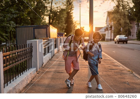 School boys running to school. School boys having fun after school. School boys running to school. School boys having fun after school. 80648260