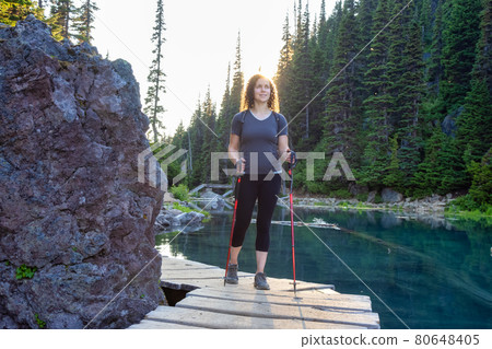 Adventurous White Caucasin Adult Woman Hiking on a trail in Canadian Nature Adventurous White Caucasin Adult Woman Hiking on a trail in Canadian Nature 80648405