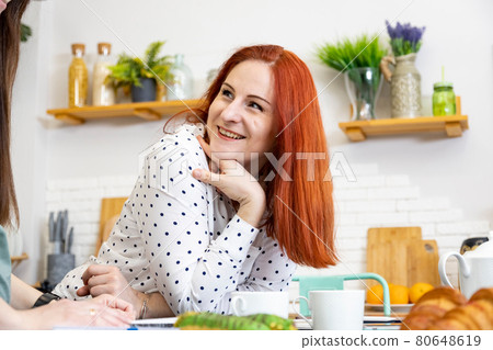 beautiful caucasian woman laughing in the kitchen 80648619