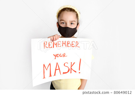 A schoolgirl in a mask draws attention to the wearing of protective masks. A schoolgirl in a mask draws attention to the wearing of protective masks. 80649012