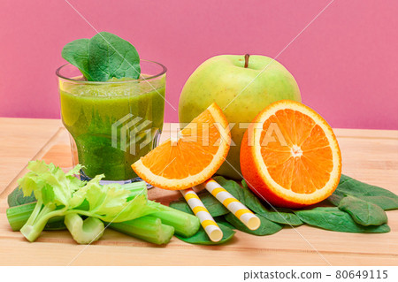 Fresh Green Smoothie of Apple, Celery, Spinach and Orange in Glass Beaker Fresh Green Smoothie of Apple, Celery, Spinach and Orange in Glass Beaker 80649115