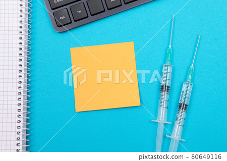 Vaccination or Revaccination Concept - Two Medical Syringe on Blue Table 80649116