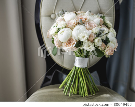 Beautiful bridal bouquet. White and pink roses and peonies. Traditional floral composition for bride on wedding ceremony. 80649493