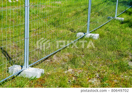 portable fence parts that are installed in concrete weight racks hold the stability of the fencing portable fence parts that are installed in concrete weight racks hold the stability of the fencing 80649702