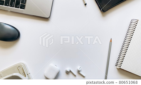 Layout on the topic of working process or education on a white background with notepad, pen, laptop, computer mouse, tablet, hole punch, headphones, pencils Layout on the topic of working process or education on a white background with notepad, pen, laptop, computer mouse, tablet, hole punch, headphones, pencils 80651068