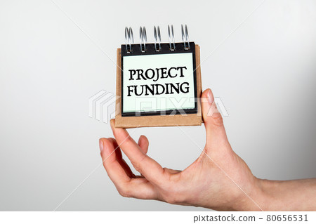 Project Funding. Notebook in woman's hands on a white background 80656531