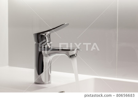 New Stainless faucet on clean wash basin sink in bathroom 80656683