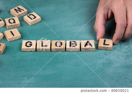 GLOBAL. Wooden alphabet letters on a green blackboard background 80658021