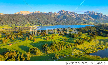 Aerial view over Lake Forggensee at the city of Fuessen in Germany Aerial view over Lake Forggensee at the city of Fuessen in Germany 80658284