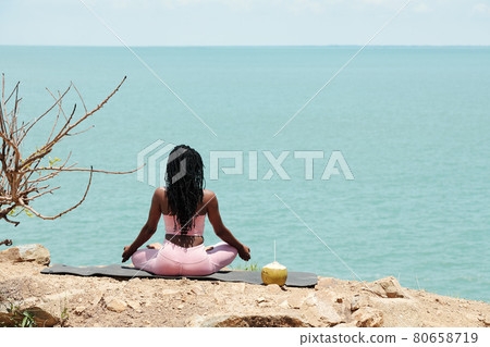 Woman Meditating in Lotus Position Woman Meditating in Lotus Position 80658719