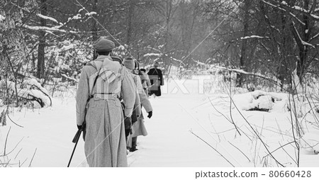 Men Dressed As White Guard Soldiers Of Imperial Russian Army In Russian Civil War Times Marching Through Snowy Winter Forest. Historical Reenactment 1917-1922. Black And White Photo Men Dressed As White Guard Soldiers Of Imperial Russian Army In Russian Civil War Times Marching Through Snowy Winter Forest. Historical Reenactment 1917-1922. Black And White Photo 80660428